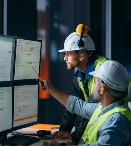 2 Construction Workers looking at data on a computer screen